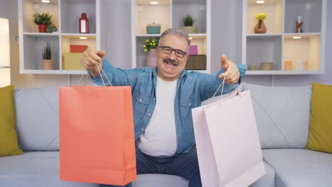 Old-man-showing-shopping-bags-to-camera.